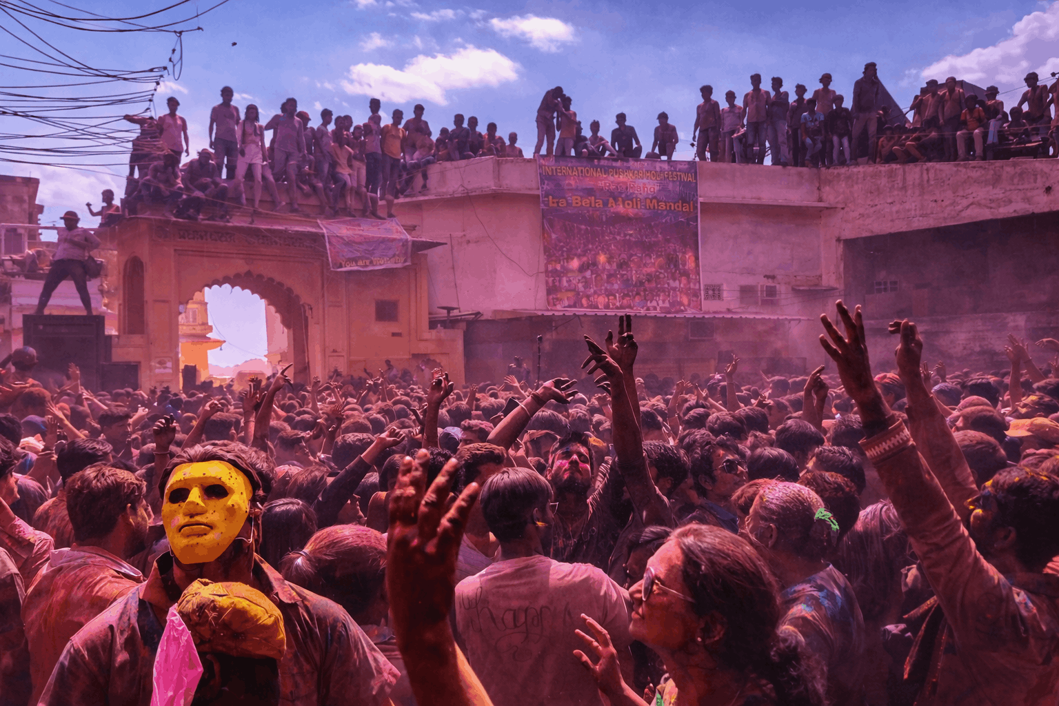 Tourists and locals playing with colors during Pushkar Holi festival